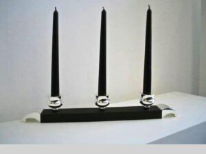 Three black candles on a stand