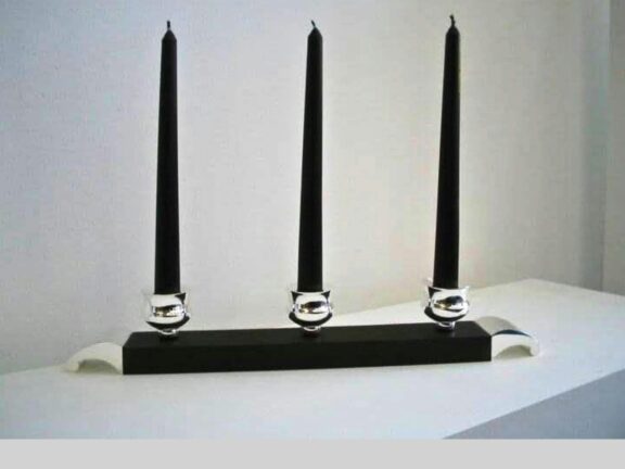 Three black candles on a stand