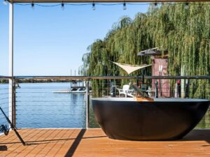 Bath tub on a wooden deck overlooking a river